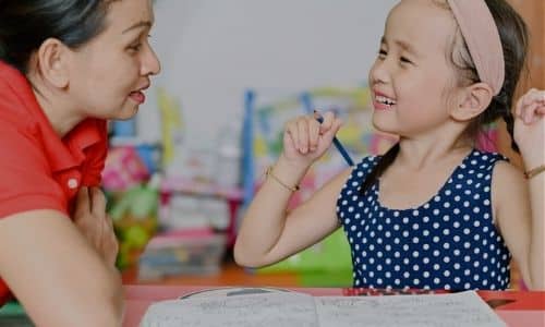 Speech therapist teaching young girl