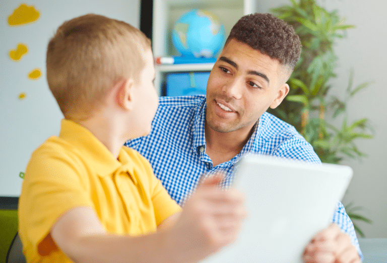 male teacher with a student in the classroom