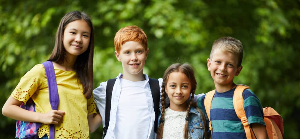 Group of happy students with backpacks