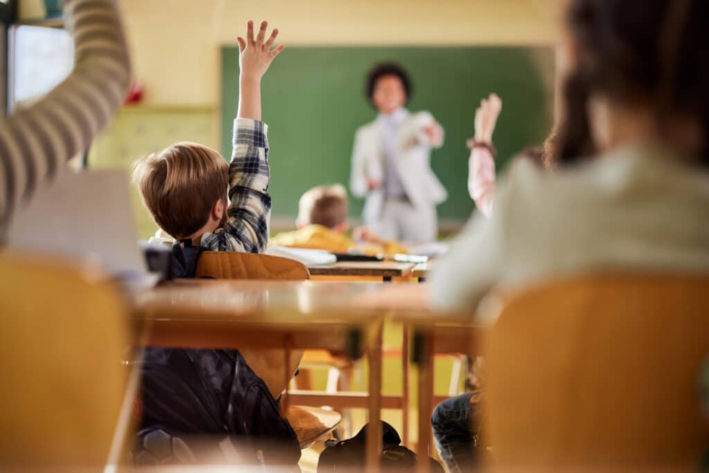 student raising hand in class