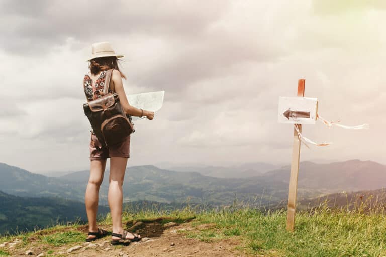 A woman looking at a map tryin to find her way